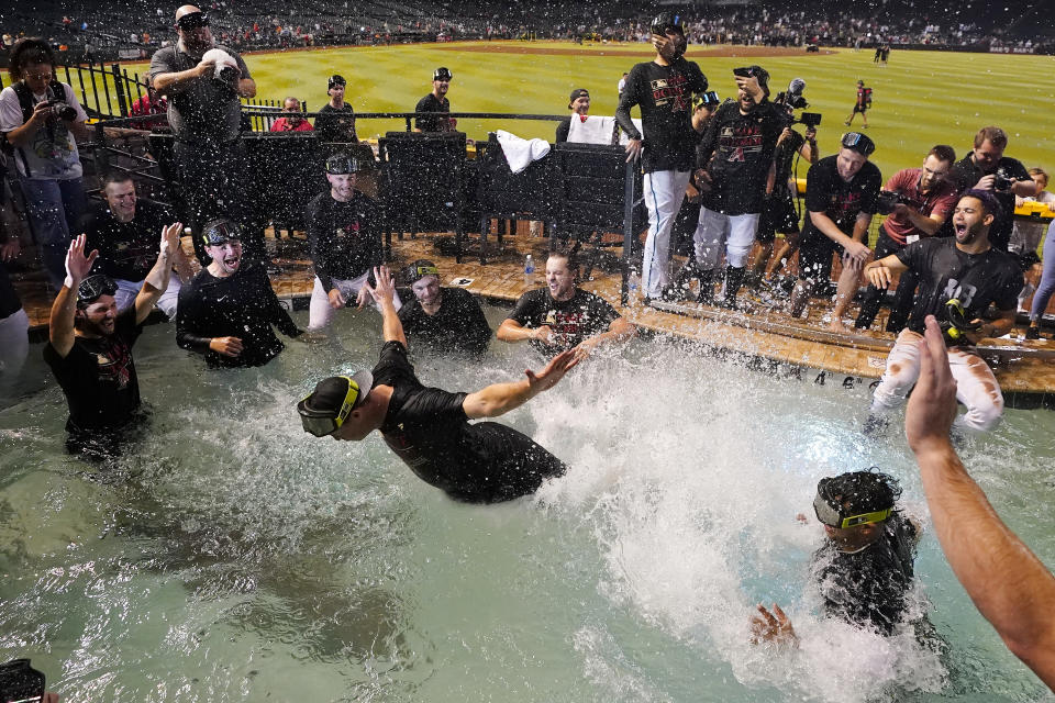 The Arizona Diamondbacks players celebrate in the Chase Field pool after clinching a Wild Card spot in the MLB playoffs after a baseball game against the Houston Astros, Saturday, Sept. 30, 2023, in Phoenix. The Astros won 1-0. (AP Photo/Ross D. Franklin)