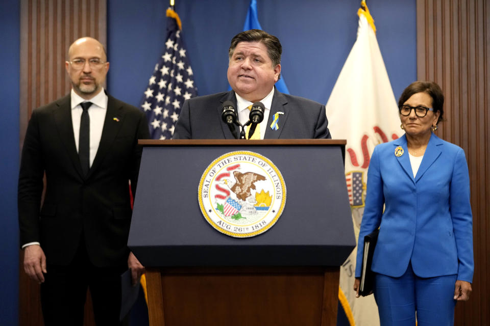 Illinois Gov. J.B. Pritzker, center, speaks as Ukrainian Prime Minister Denys Shmyhal, left, and U.S. Special Representative for Ukraine's Economic Recovery Penny Pritzker listen to him at a news conference in Chicago, Tuesday, April 16, 2024. They delivered joint remark recognizing the Illinois-Ukraine partnership. (AP Photo/Nam Y. Huh)