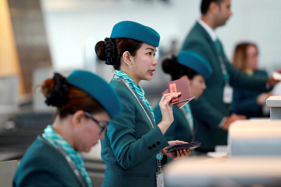 <p>Staff speaks with passengers at Hamad International Airport in Doha, Qatar, June 7, 2017. (Photo: Naseem Zeitoon/Reuters) </p>