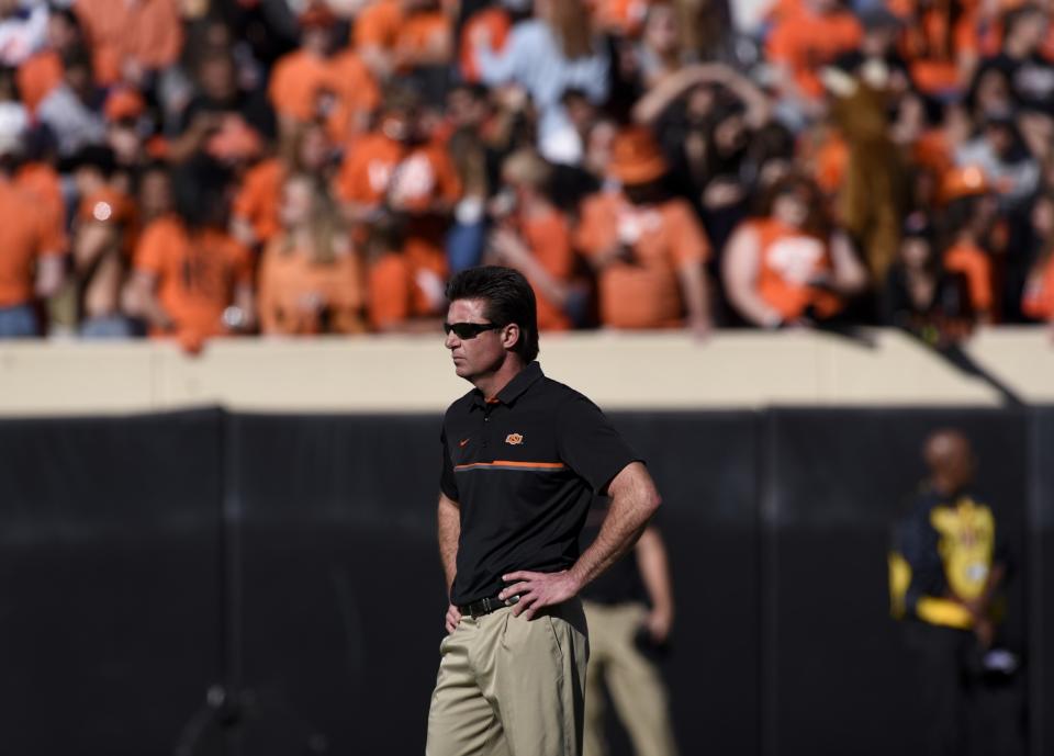 Oklahoma State head coach Mike Gundy watches his team prractice before the start of an NCAA college football game with Texas Tech in Stillwater, Okla., Saturday, Nov. 12, 2016.(AP Photo/Brody Schmidt)