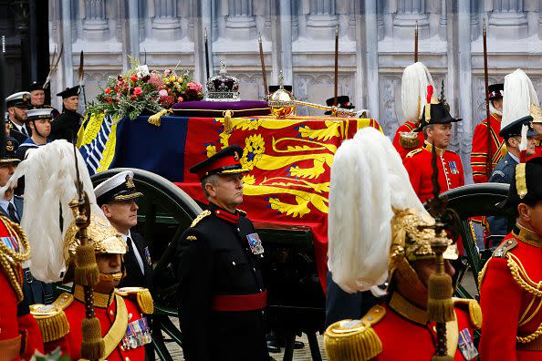 LONDON, ENGLAND - SEPTEMBER 19: The coffin of Queen Elizabeth II with the Imperial State Crown resting on top i proceeds towards Westminster Abbey on September 19, 2022 in London, England. Elizabeth Alexandra Mary Windsor was born in Bruton Street, Mayfair, London on 21 April 1926. She married Prince Philip in 1947 and ascended the throne of the United Kingdom and Commonwealth on 6 February 1952 after the death of her Father, King George VI. Queen Elizabeth II died at Balmoral Castle in Scotland on September 8, 2022, and is succeeded by her eldest son, King Charles III.  (Photo by Tristan Fewings/Getty Images)