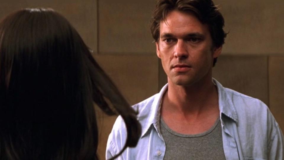 The worst villain ever, a man with normal features, looks at a woman in Mission: Impossible II