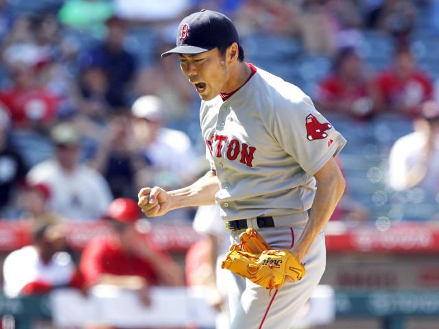 Red Sox closer Koji Uehara reacts after striking out the Angels' Josh Hamilton on Sunday. (AP Photo)