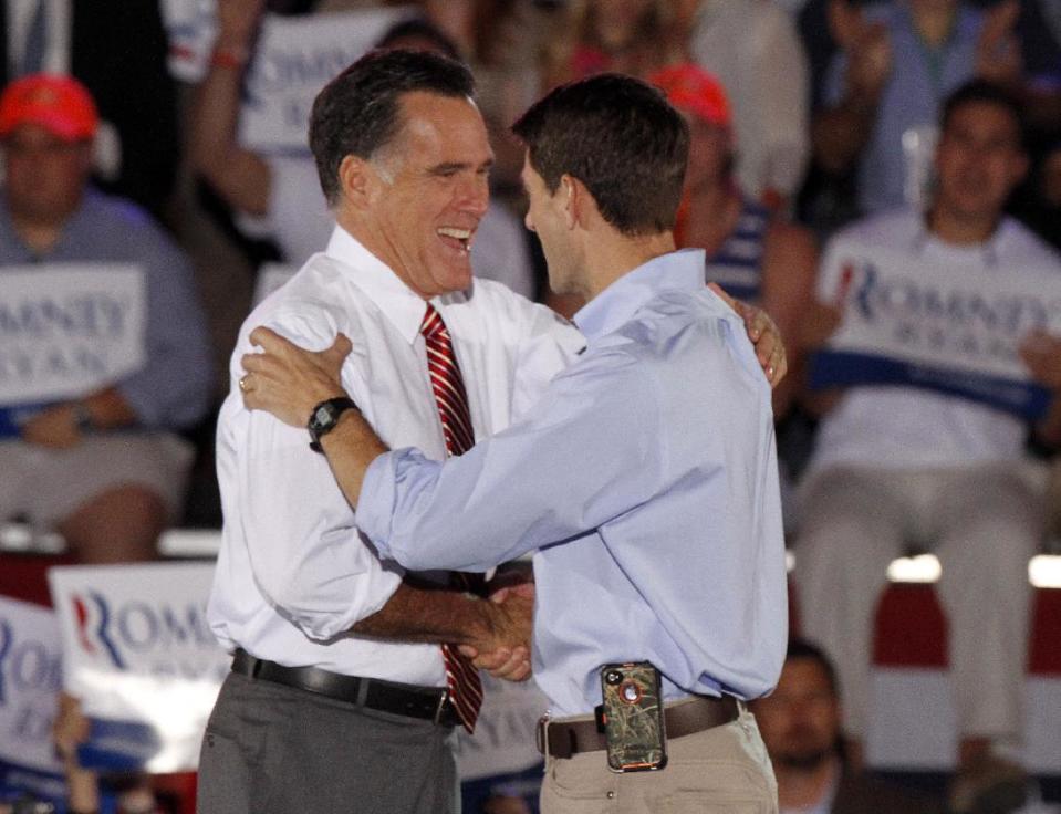 Republican presidential candidate former Massachusetts Gov. Mitt Romney and his running mate Rep. Paul Ryan, R-Wis., embrace during a rally in Fishersville, Va., Thursday, Oct. 4, 2012. (AP Photo/Steve Helber)