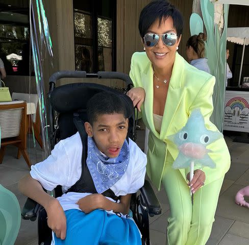 <p>Kris Jenner Instagram</p> Kris Jenner poses next to Amari at a birthday celebration.