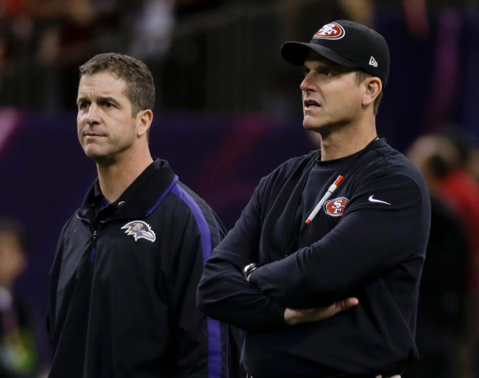 Then-San Francisco 49ers coach Jim Harbaugh, right, and Baltimore Ravens coach John Harbaugh watch practice before the NFL Super Bowl XLVII football game between their teams in New Orleans in 2013. If they ever meet in the Big Game again, make sure you don't call it the Harbowl.
