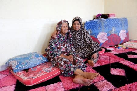 Mabrouka al-Twati, 80, a Libyan displaced woman, sits with her daughter Tabra al-Hamali in a school used as a shelter at Abu Slim district in Tripoli