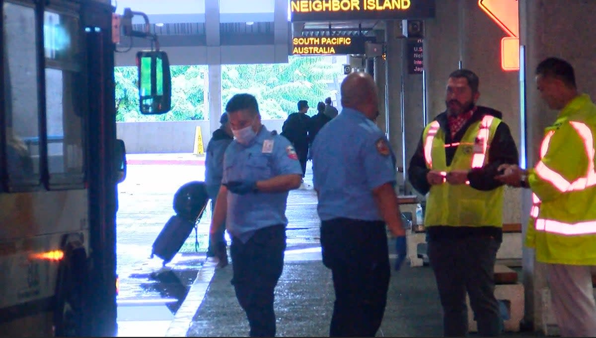 This image taken from video provided by Hawaii News Now shows the scene outside the international airport in Honolulu after nearly a dozen people were seriously injured when a flight to Hawaii hit severe turbulence on Sunday, 18 December 2022 (AP)