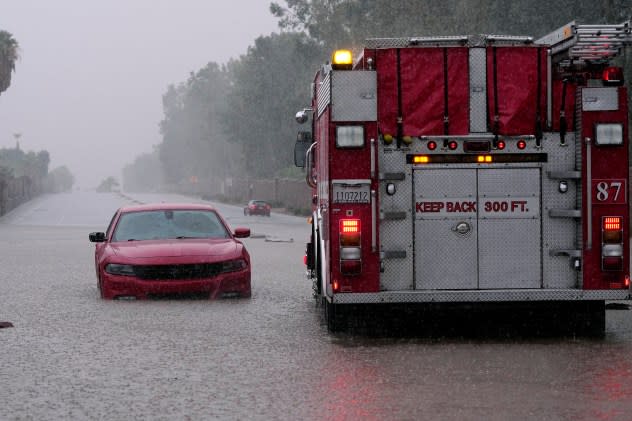 A fire truck pulls away after a motorist became stranded in rising floodwaters caused by torrential rain brought by Tropical Storm Hilary, Sunday, Aug. 20, 2023, in Palm Desert, Calif. (AP/Mark J. Terrill)