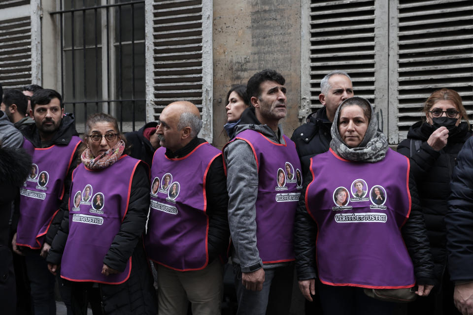 Kurdish activists wear jacket printed with portraits of three women Kurdish activists who were found shot dead in 2013, in Paris, Monday, Dec. 26, 2022 in Paris. A 69-year-old Frenchman is facing preliminary charges of racially motivated murder, attempted murder and weapons violations over Friday's shooting, prosecutors said. ( AP Photo/Lewis Joly)