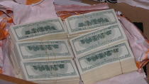 In this photo provided by Bulgaria's Interior Ministry on Tuesday, March 16, 2021, counterfeit money at a printing office in a university, in Sofia. Bulgarian authorities say police seized high-quality forged banknotes produced at a printing office at a university in the capital. In a joint operation with the U.S. Secret Service, Bulgarian police detained two people and seized a printing machine and equipment for printing money, along with large amounts of counterfeit U.S. dollar and euro notes. (Bulgarian Interior Ministry via AP)