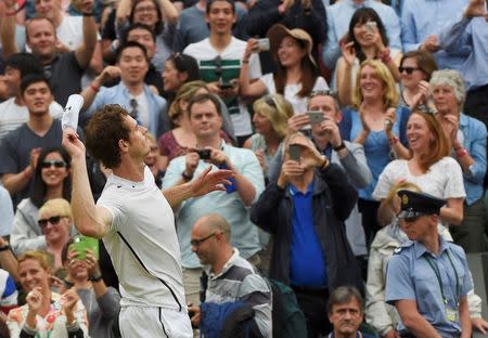 Britain Tennis - Wimbledon - All England Lawn Tennis & Croquet Club, Wimbledon, England - 2/7/16 Great Britain's Andy Murray throws his sweatband into the crowd as he celebrates winning his match against Australia's John Millman REUTERS/Toby Melville