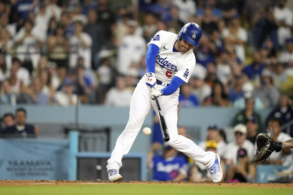 Los Angeles Dodgers' Freddie Freeman hits a two RBI single during the eighth inning of a baseball game against the Milwaukee Brewers Friday, July 5, 2024, in Los Angeles. (AP Photo/Mark J. Terrill)