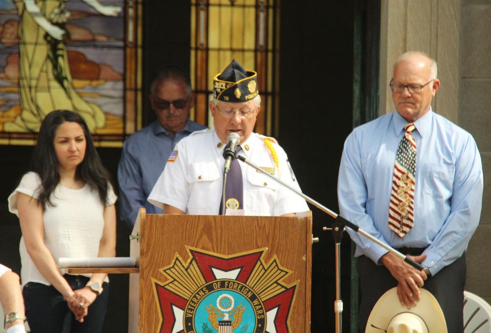 Steve Worthington of the American Legion reads "Flanders Field" at the Memorial Day serve at Southside Cemetery Monday.