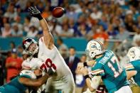 Dec 14, 2015; Miami Gardens, FL, USA; Miami Dolphins quarterback Ryan Tannehill (17) throws a pass over New York Giants defensive tackle Markus Kuhn (78) during the second half at Sun Life Stadium. Steve Mitchell-USA TODAY Sports