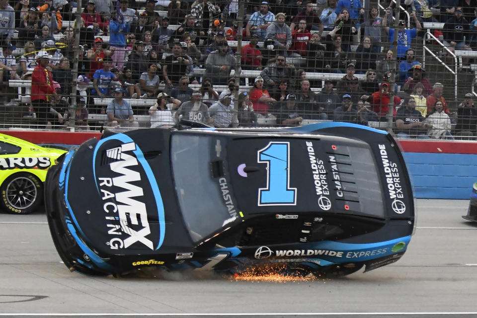 Sparks fly as Ross Chastain (1) slides on the track after making contact with Kyle Busch during the NASCAR All-Star auto race at Texas Motor Speedway in Fort Worth, Texas, Sunday, May 22, 2022. (AP Photo/Randy Holt)