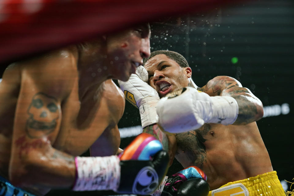 Gervonta Davis, right, hits Mario Barrios during the WBA Super Lightweight world championship boxing match on Saturday, June 26, 2021, in Atlanta. Davis won. (AP Photo/Brynn Anderson)