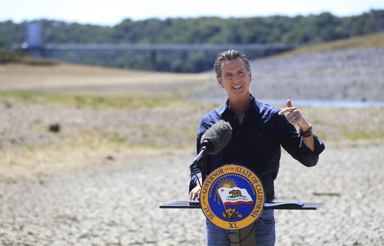 California Gov. Gavin Newsom speaks at a news conference in the parched basin of Lake Mendocino in Ukiah, Calif., Wednesday, April 21, where he announced he would proclaim a drought emergency for Mendocino and Sonoma counties. 