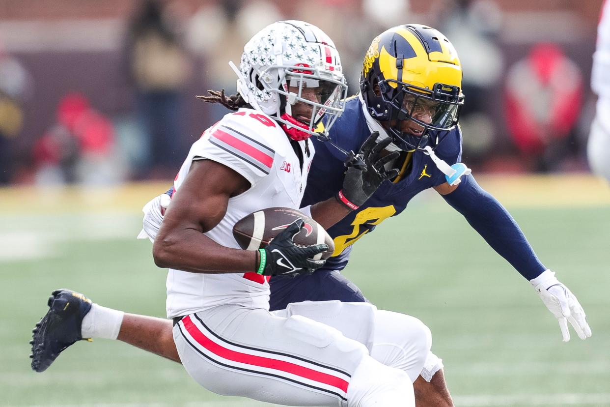 Michigan defensive back Will Johnson defends Ohio State receiver Marvin Harrison Jr. during the second half at Michigan Stadium in Ann Arbor on Saturday, Nov. 25, 2023.