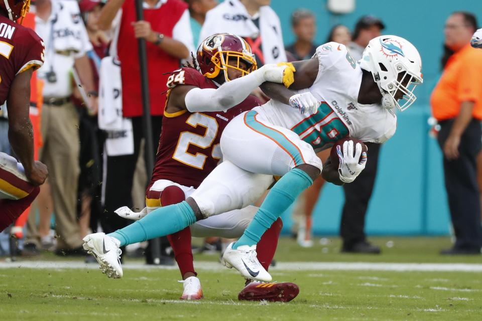 Washington Redskins cornerback Josh Norman (24) pulls down Miami Dolphins wide receiver Preston Williams (18), during the second half at an NFL football game, Sunday, Oct. 13, 2019, in Miami Gardens, Fla. (AP Photo/Wilfredo Lee)