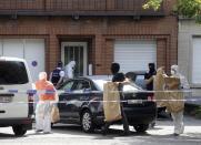 <p>Police and forensic officers remove items during a house search in the Molenbeek district of Brussels on Wednesday, June 21, 2017. (Francois Walschaerts/AP) </p>