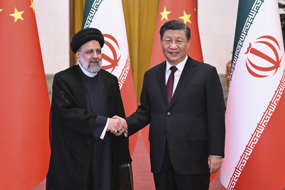 FILE - In this photo released by Xinhua News Agency, Visiting Iranian President Ebrahim Raisi, left, shakes hands with Chinese President Xi Jinping before their meeting at the Great Hall of the People in Beijing, Feb. 14, 2023. (Yan Yan/Xinhua via AP, File)