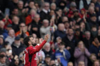 Manchester United's Bruno Fernandes celebrates after scoring his side's first goal during the English Premier League soccer match between Manchester United and Liverpool at the Old Trafford stadium in Manchester, England, Sunday, April 7, 2024. (AP Photo/Dave Thompson)