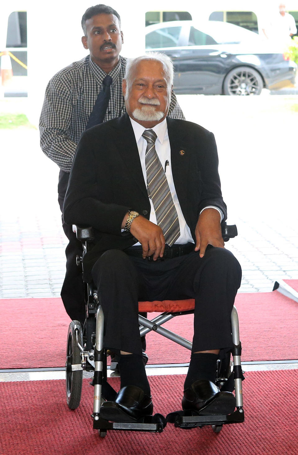 In this picture taken March 25, 2014, veteran Malaysian opposition lawmaker Karpal Singh, front, arrives at Parliament house in Kuala Lumpur, Malaysia. Singh, an eminent lawyer who had been detained without trial under security laws and battled numerous sedition charges, died early Thursday, April 17, 2014 in a road accident. He was 73. (AP Photo) MALAYSIA OUT, NO SALES, NO ARCHIVE