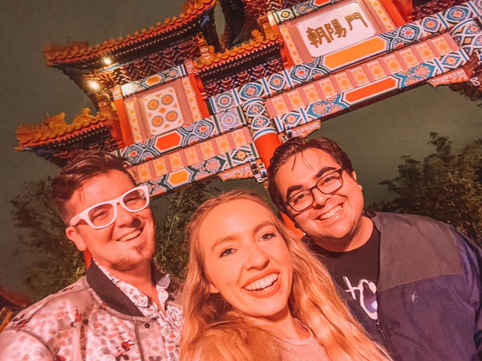 Author posing with two friends on each side in front of China Pavilion.