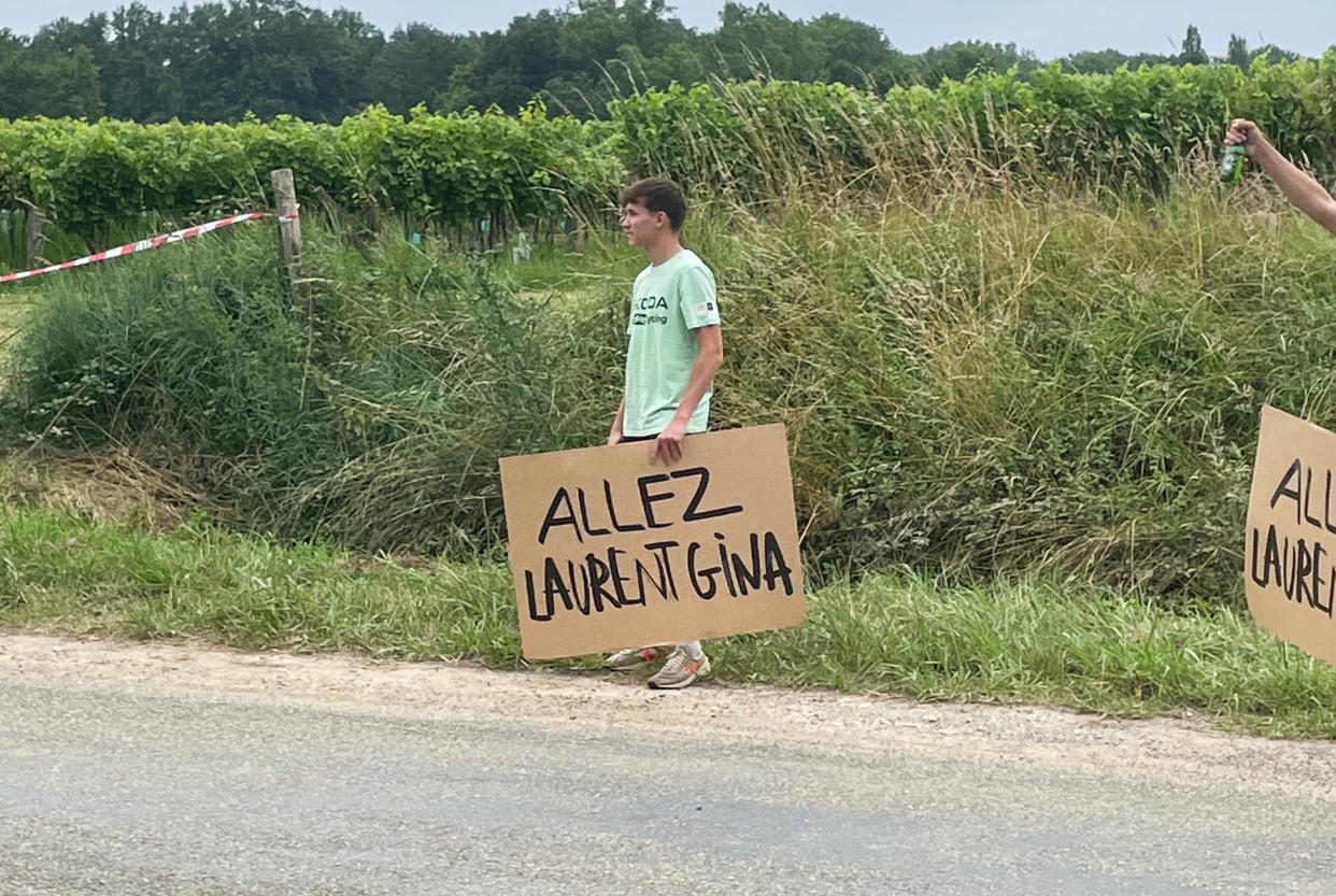  A fan at the Tour de France holding a sign that says Allez Laurent Gina 