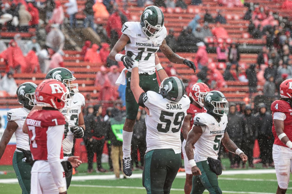 Michigan State Spartans wide receiver Tre Mosley celebrates a touchdown reception with center Nick Samac during the second half against the Rutgers Scarlet Knights at SHI Stadium on October 14, 2023 in Piscataway, New Jersey.