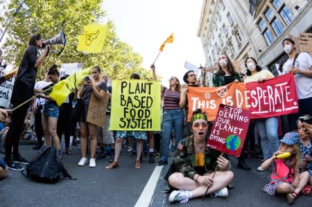 People demonstrate during an Extinction Rebellion protest outside the Brazilian embassy in London