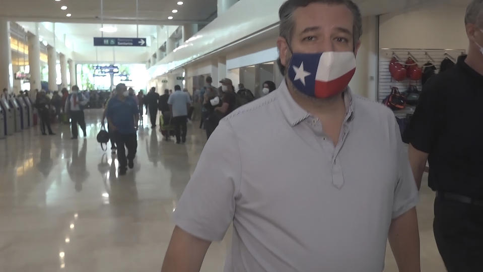 FILE - In this Thursday, Feb. 18, 2021 image from video, Sen. Ted Cruz, R-Texas, walks to check in for his flight back to the U.S., at Cancun International Airport in Cancun, Mexico. On Friday, Feb. 19, 2021, The Associated Press reported on stories circulating online incorrectly asserting that in 2016, Cruz tweeted, “I’ll believe in climate change when Texas freezes over.” The tweet is fabricated. It cannot be found on Cruz’s verified Twitter account, nor is it on websites that track deleted tweets by public officials. (AP Photo/Dan Christian Rojas)