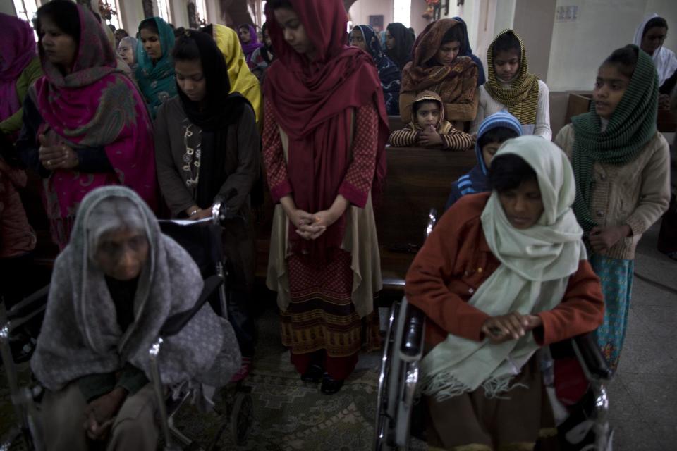 In this Sunday, Feb. 16, 2014, photo, patients on wheelchairs, and Pakistanis living nearby, pray during a Sunday mass, at St. Joseph’s Hospice, in Rawalpindi, Pakistan. Mohammed Aqeel spent weeks at home in Pakistan waiting for death after suffering a debilitating spinal cord injury in a car crash before friends suggested he come to St. Joseph’s Hospice on the outskirts of the capital, Islamabad. Now 13 years later, his life and those of some 40 others who live on its grounds might be changed forever as this hospital of last resort faces closure over its rising debts. (AP Photo/Muhammed Muheisen)