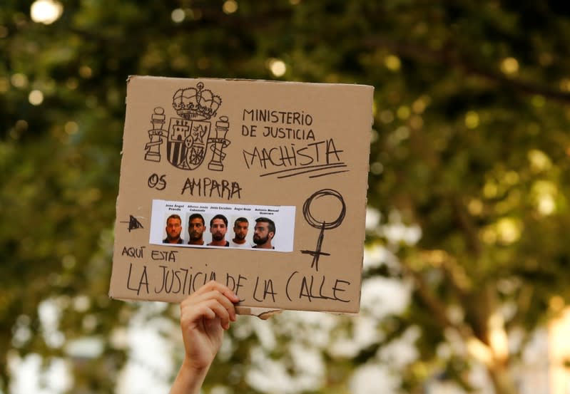 FILE PHOTO: A protester holds a sign during a demonstration against the release on bail of five men known as the "Wolf Pack" cleared of gang rape of a teenager and convicted of a lesser crime of sexual abuse in Seville