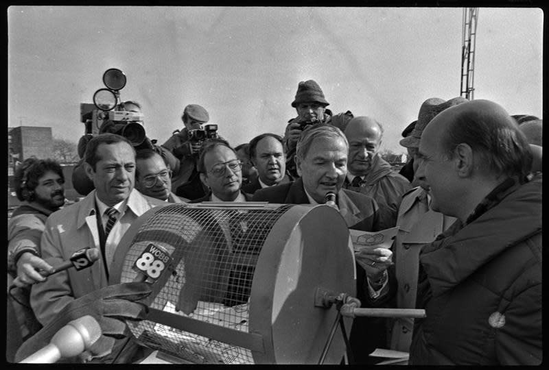 Mayor Koch conducting a homeownership lottery in December 1983 using bingo balls. The drawing took place in Windsor Terrace, Brooklyn.