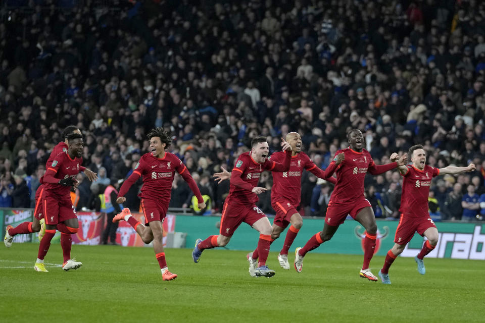 Liverpool players celebrate after winning the English League Cup final soccer match between Chelsea and Liverpool at Wembley stadium in London, Sunday, Feb. 27, 2022. Liverpool won a penalty shootout 11-10 after the match ended tied 0-0. (AP Photo/Alastair Grant)