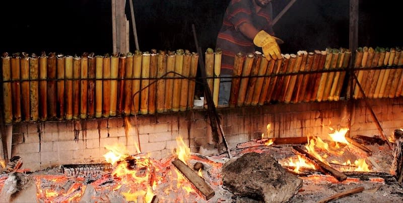 Dino’s mother and siblings often pitch in to help with the cooking and preparation of the lemang. — Picture courtesy of Dino