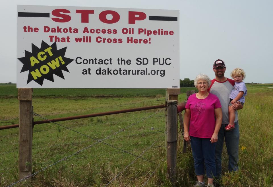 When the Dakota Access Pipeline was proposed to run through Peggy Hoogestraat's farmland west of Hartford in 2014, she erected this sign to generate opposition to the pipeline among her neighbors. Hoogestraat is shown with her son, Matthew Anderson and granddaughter Kendall Anderson. In the end, DAPL officials used eminent domain to lay the pipeline across Hoogestraat's land.