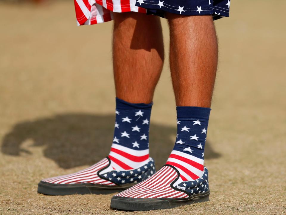 A person wearing American Flag shoes, socks, and shorts.