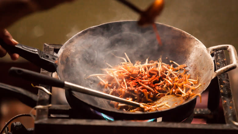 Person cooking pad Thai