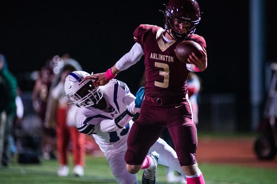 Arlington's Michael Rescigno runs in a touchdown while fending off New Rochelle's Bryce Miller during the Section 1 class AA quarterfinal football game at Arlington High School in Freedom Plains, NY on Friday, October 28, 2022. Arlington defeated New Rochelle. KELLY MARSH/FOR THE POUGHKEEPSIE JOURNAL