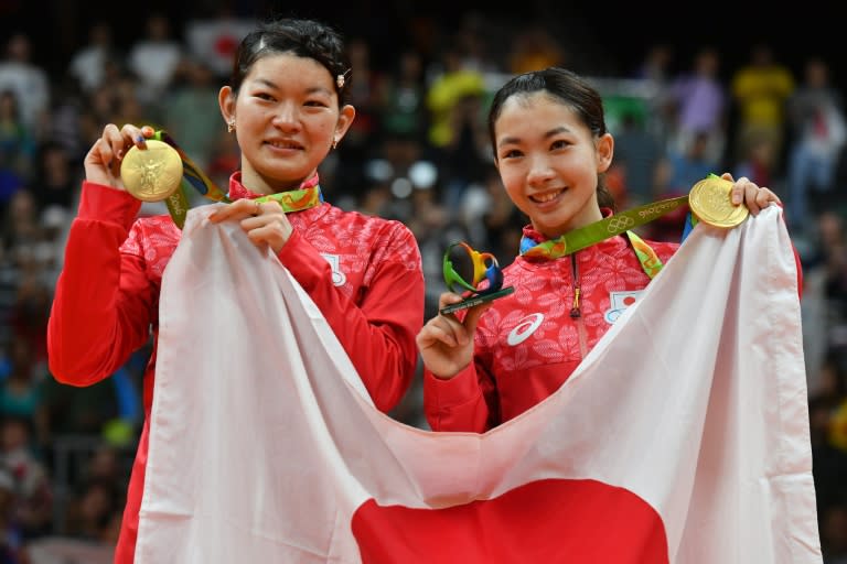 Japan's gold medalists Misaki Matsutomo and Ayaka Takahashi (L) stand with their medals on the podium following the final women's doubles badminton match in Rio de Janeiro on August 18, 2016