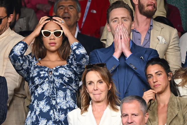 <p>Karwai Tang/WireImage</p> Zawe Ashton and Tom Hiddleston watch Carlos Alcaraz vs Novak Djokovic in the Wimbledon Tennis Championships in July 2023.