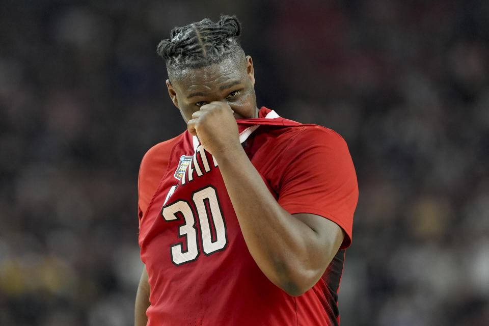 North Carolina State forward DJ Burns Jr. (30) wipes his face after their loss against Purdue during a NCAA college basketball game at the Final Four, Saturday, April 6, 2024, in Glendale, Ariz. (AP Photo/David J. Phillip)