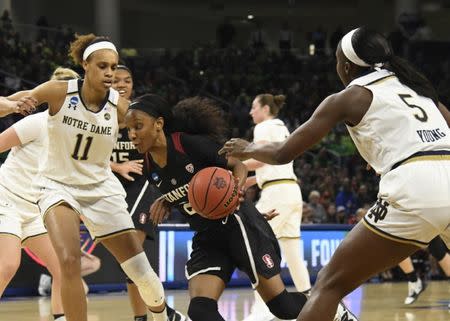 Apr 1, 2019; Chicago, IL, USA; Stanford Cardinal guard Kiana Williams (23) drives to the basket as Notre Dame Fighting Irish forward Brianna Turner (11) and guard Jackie Young (5) defend her during the first half in the championship game of the Chicago regional in the women's 2019 NCAA Tournament at Wintrust Arena. Mandatory Credit: David Banks-USA TODAY Sports