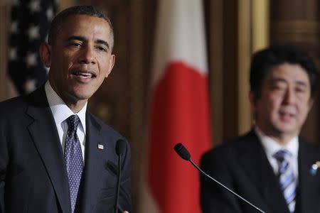 U.S. President Barack Obama addresses a news conference with Japanese Prime Minister Shinzo Abe (R) at the Akasaka guesthouse in Tokyo April 24, 2014. REUTERS/Junko Kimura-Matsumoto/Pool