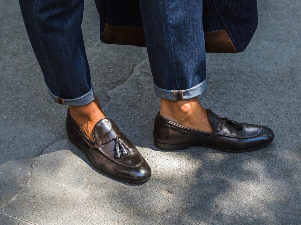 man wearing jeans rolled at the ankles and nice brown loafers