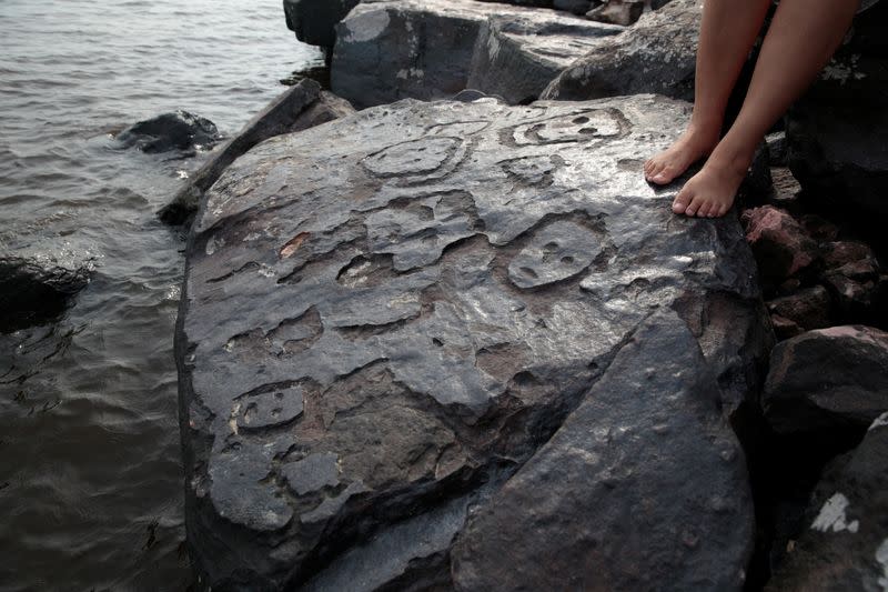 Ancient carvings on Amazon river rock exposed by falling water level during drought in Manaus