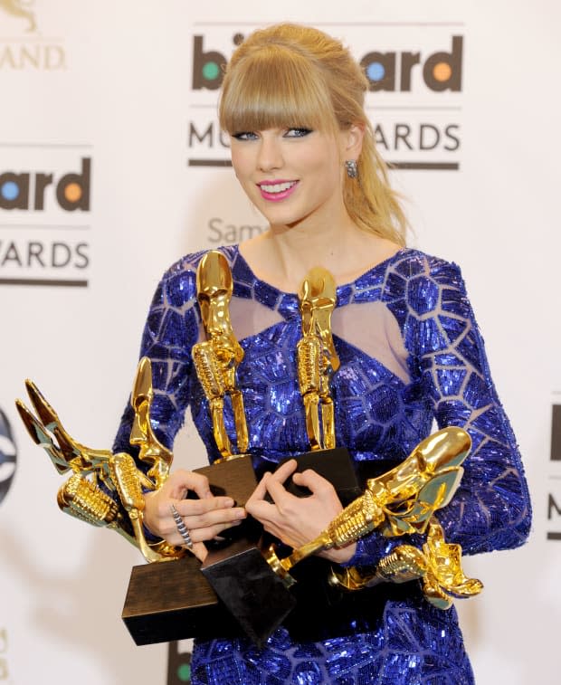 <p> Taylor Swift beams as she clutches her trophies at the <a href="https://parade.com/1339500/alexandra-hurtado/billboard-music-awards-2022/" rel="nofollow noopener" target="_blank" data-ylk="slk:Billboard Music Awards;elm:context_link;itc:0;sec:content-canvas" class="link ">Billboard Music Awards</a> on May 19, 2013.</p><p>Gregg DeGuire/WireImage</p>